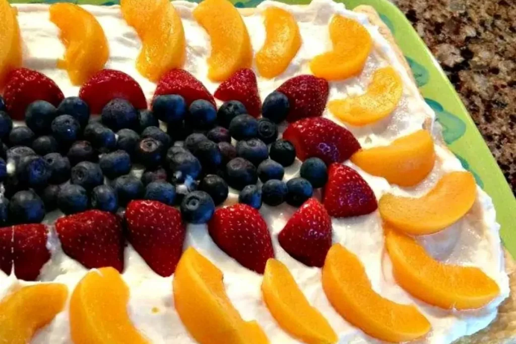 A close up of Crescent Rolls Fruit Tart with peaches and berries.