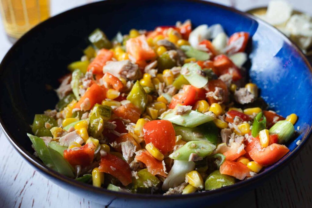 Israeli Tuna Salad With Pickles And Corn in blue bowl.