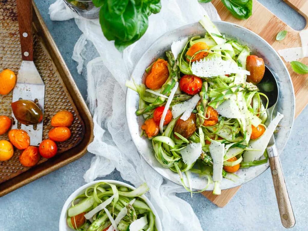 Lemony asparagus tomato salad with cherry tomatoes and herbs.