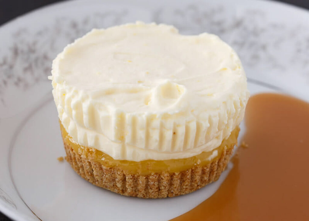 Pineapple Ice Cream Cake on a white plate next to a pool of sauce.