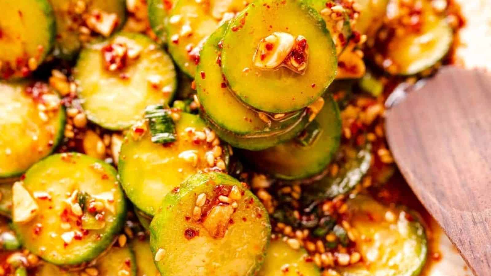 Close up on Spicy Korean Cucumber Salad with wooden spoon.