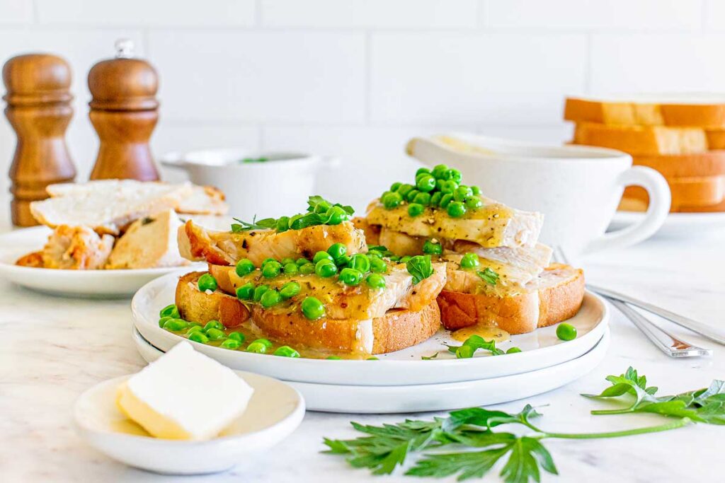 A plate of bread with peas and butter on it.