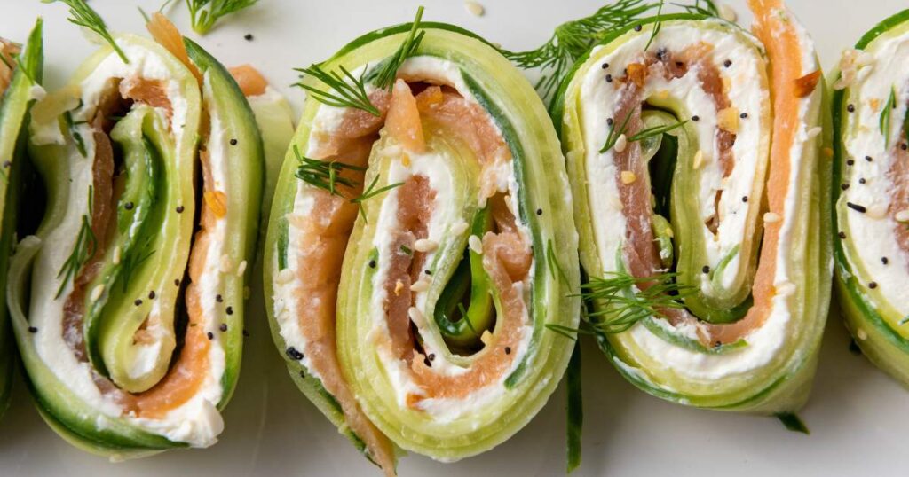 Close-up of cucumber pinwheels filled with smoked salmon, cream cheese, and fresh dill.