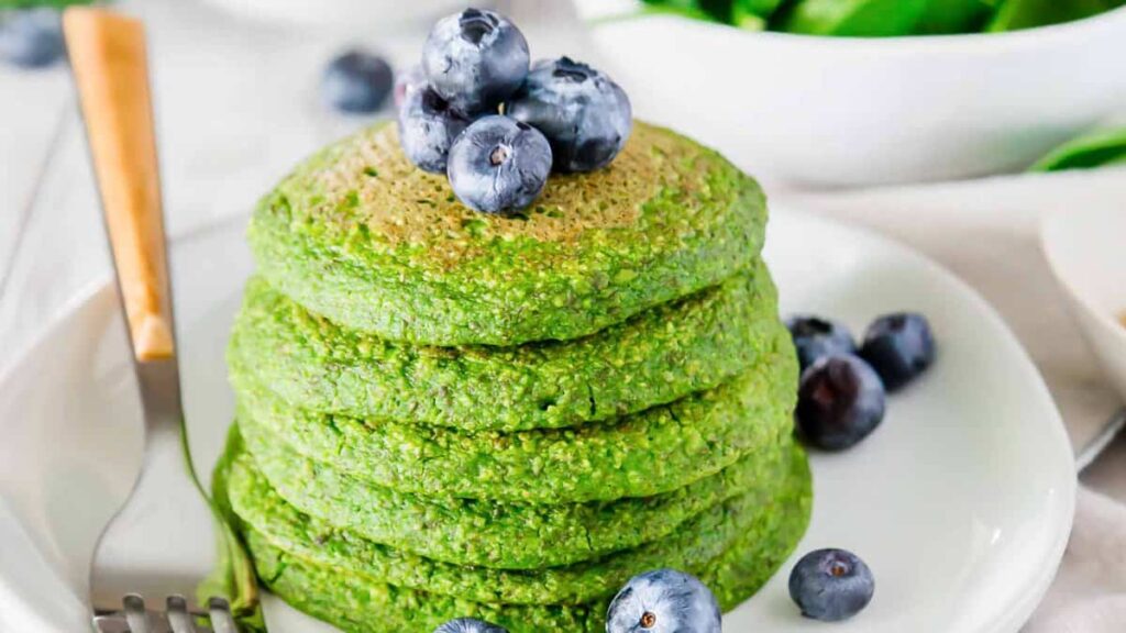 Stack of green pancakes on a plate, tinted festive for St. Patrick’s Day.