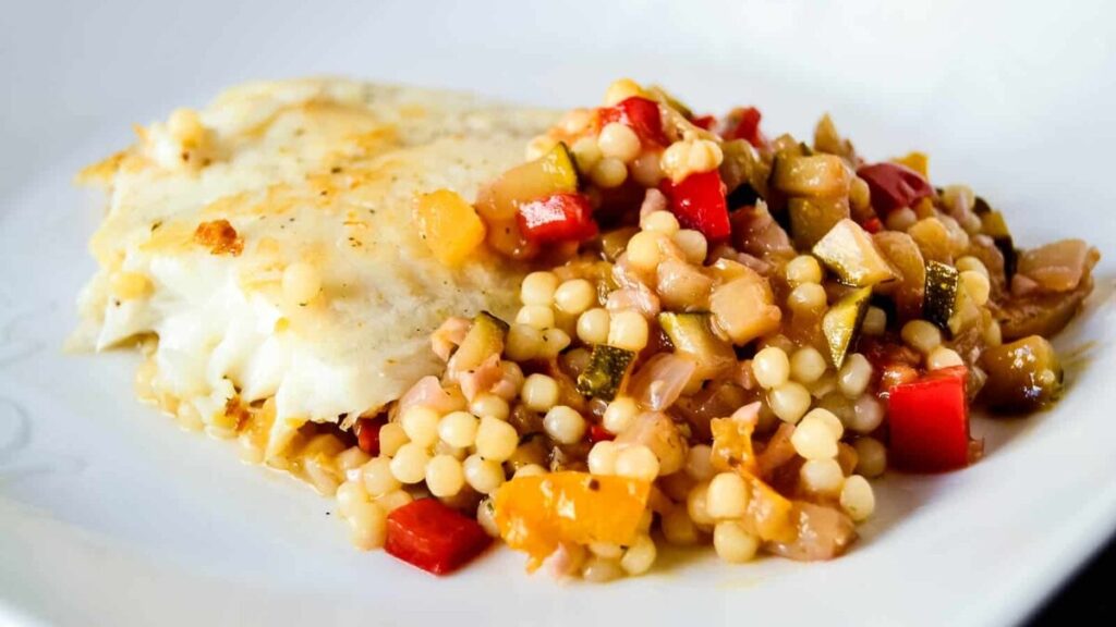 Loaded with the garden fresh vegetables this summer veggie couscous is topped with sauteed tilapia and paired with remarkably versatile garnacha wine.
