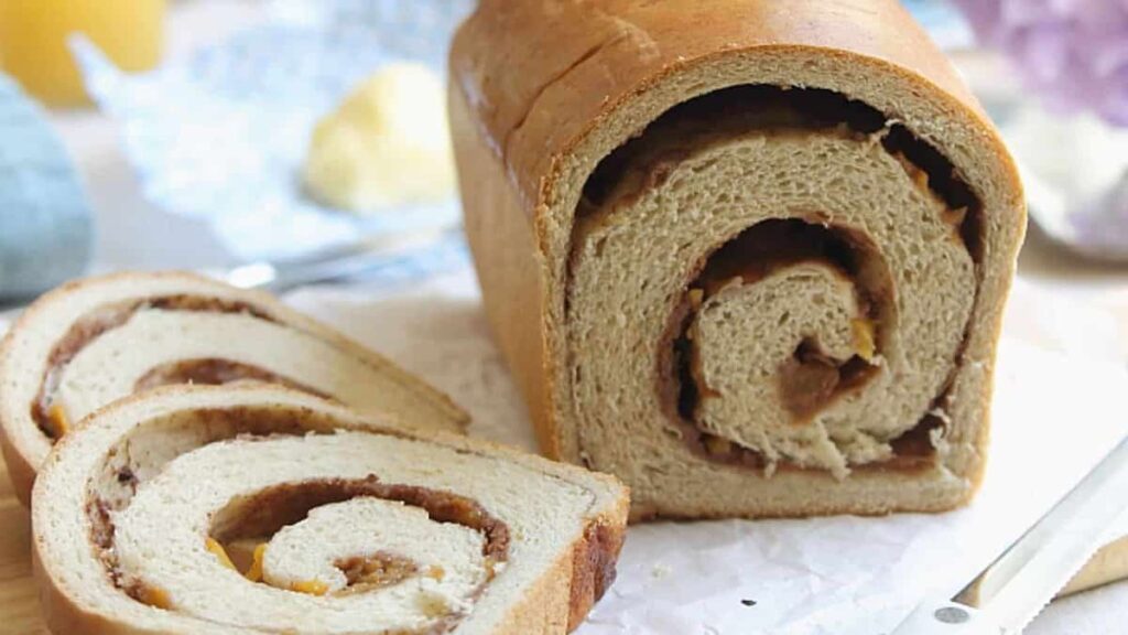 Peach cinnamon swirl bread with sliced peaches and cinnamon sugar swirl.