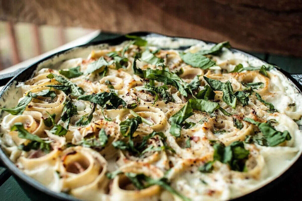 Lasagna roll ups in cast iron pan.