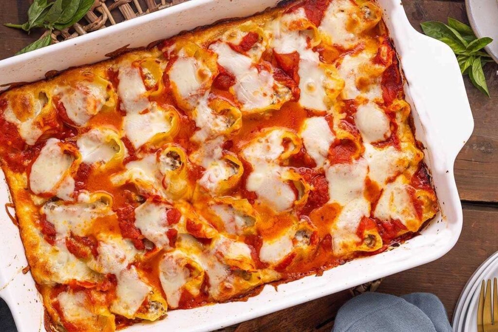 Ricotta beef stuffed shells in a white baking dish.