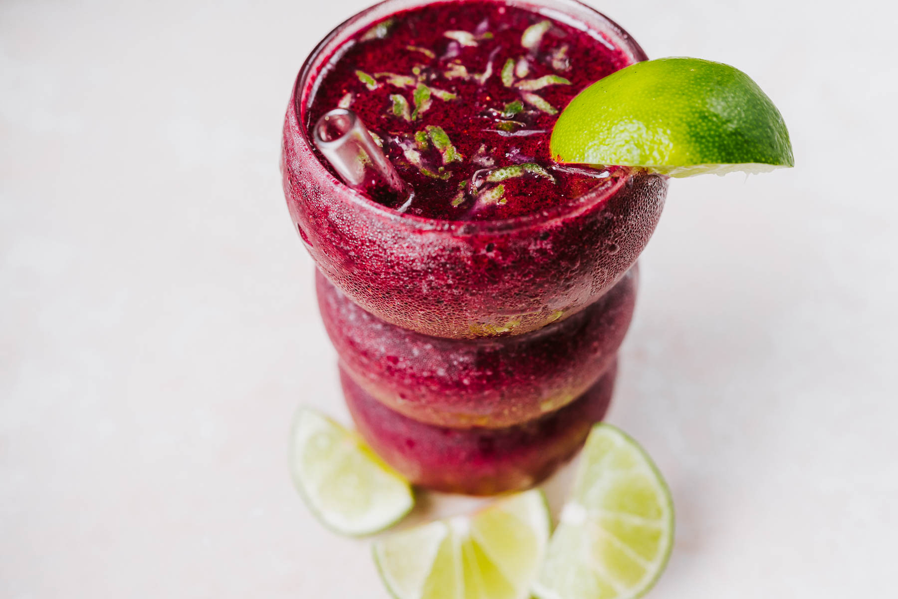 A glass of frozen blueberry margarita mocktail.