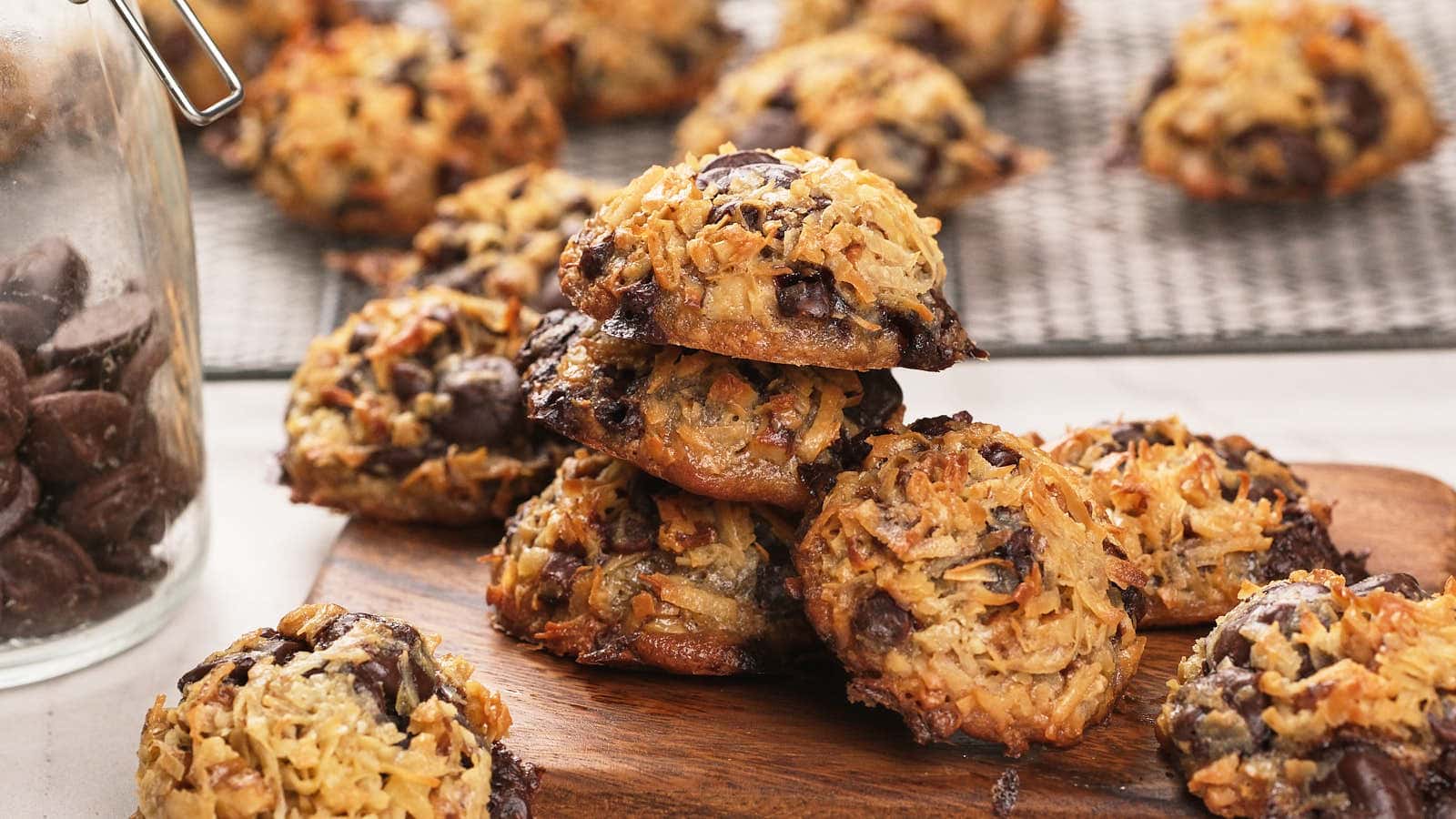 Keto magic cookies cooling on a black wire rack over a marble surface.