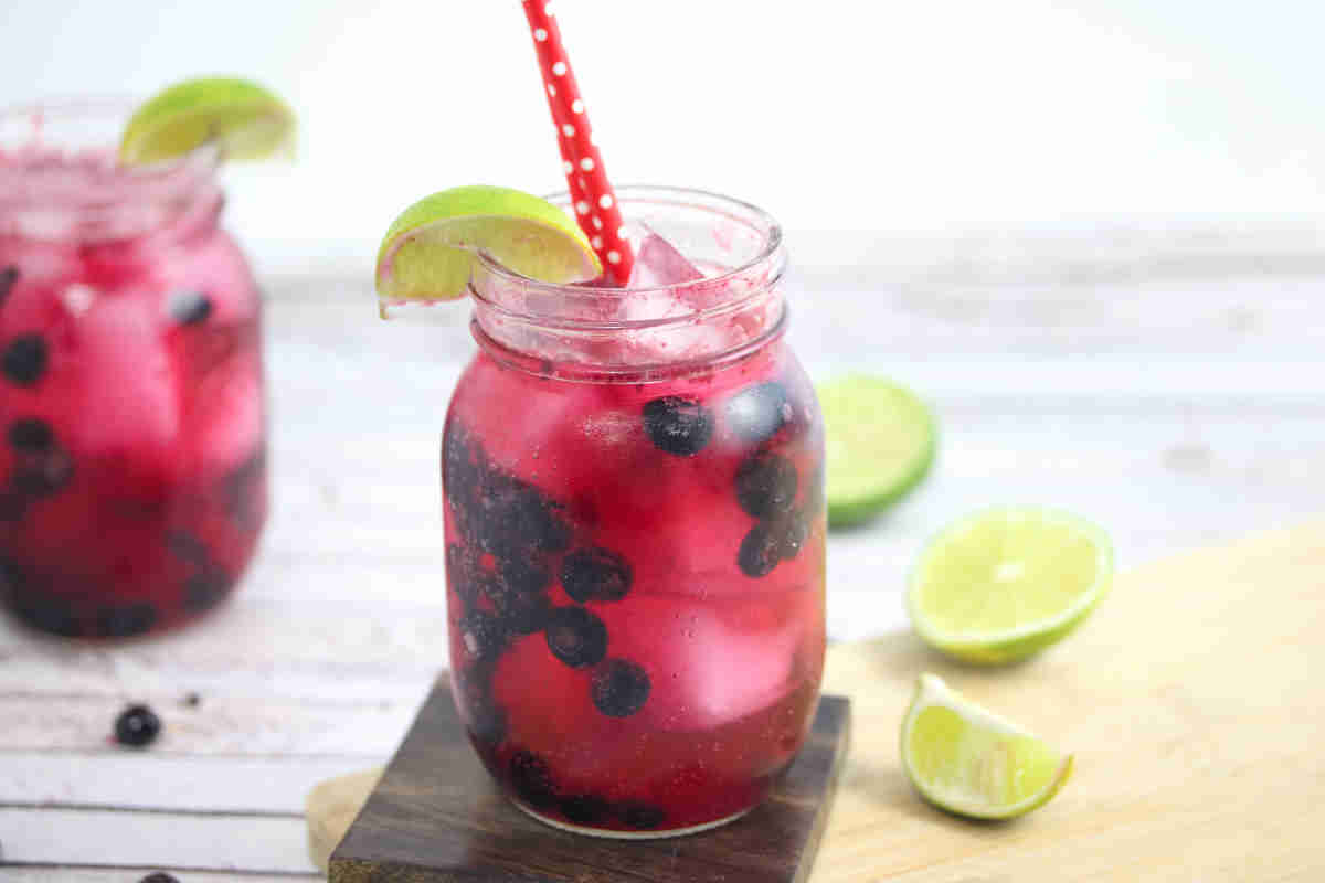A glass of sparkling blueberry mocktail.