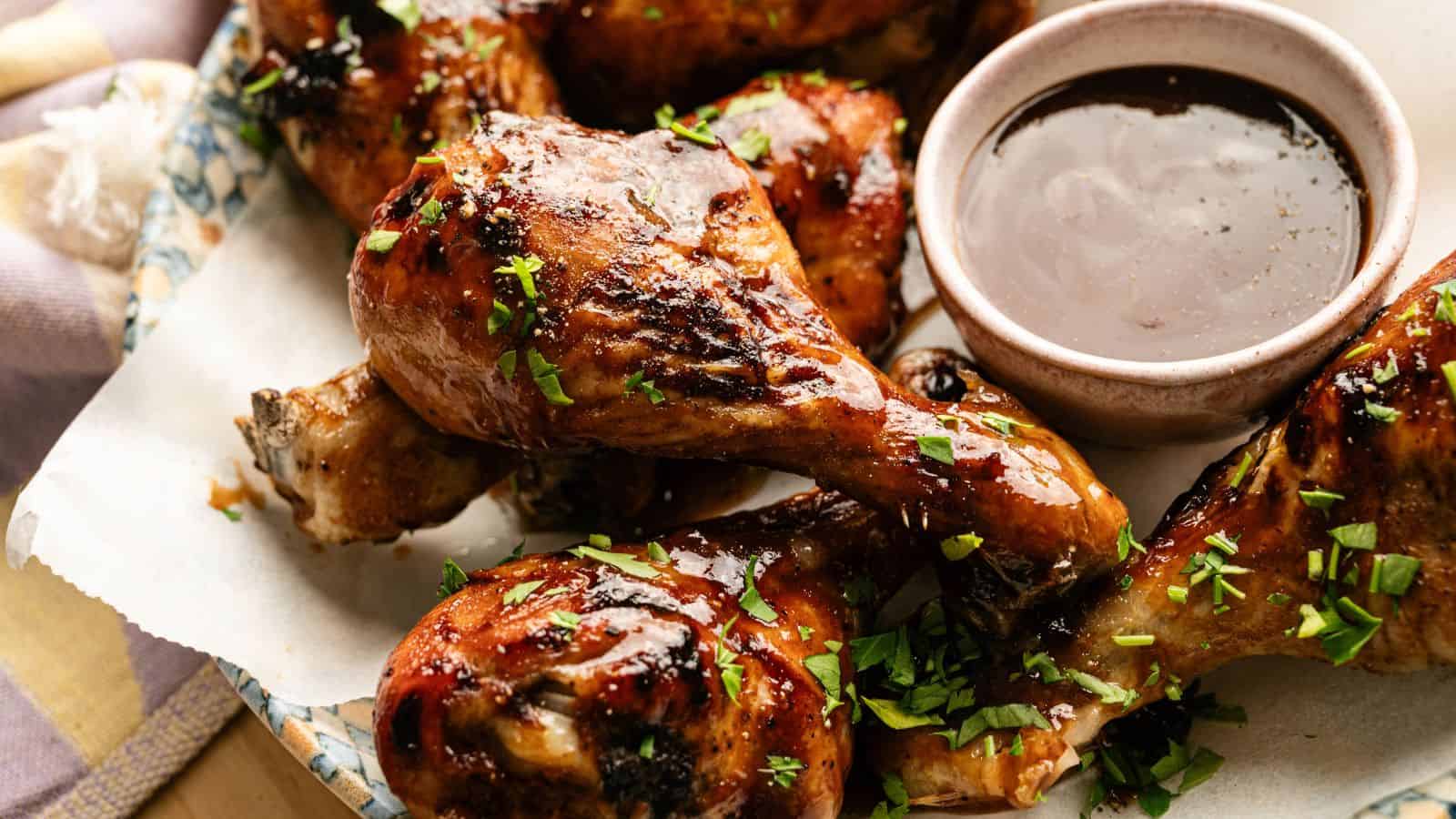 Juicy, crispy glazed chicken drumsticks with herbs and dipping sauce.