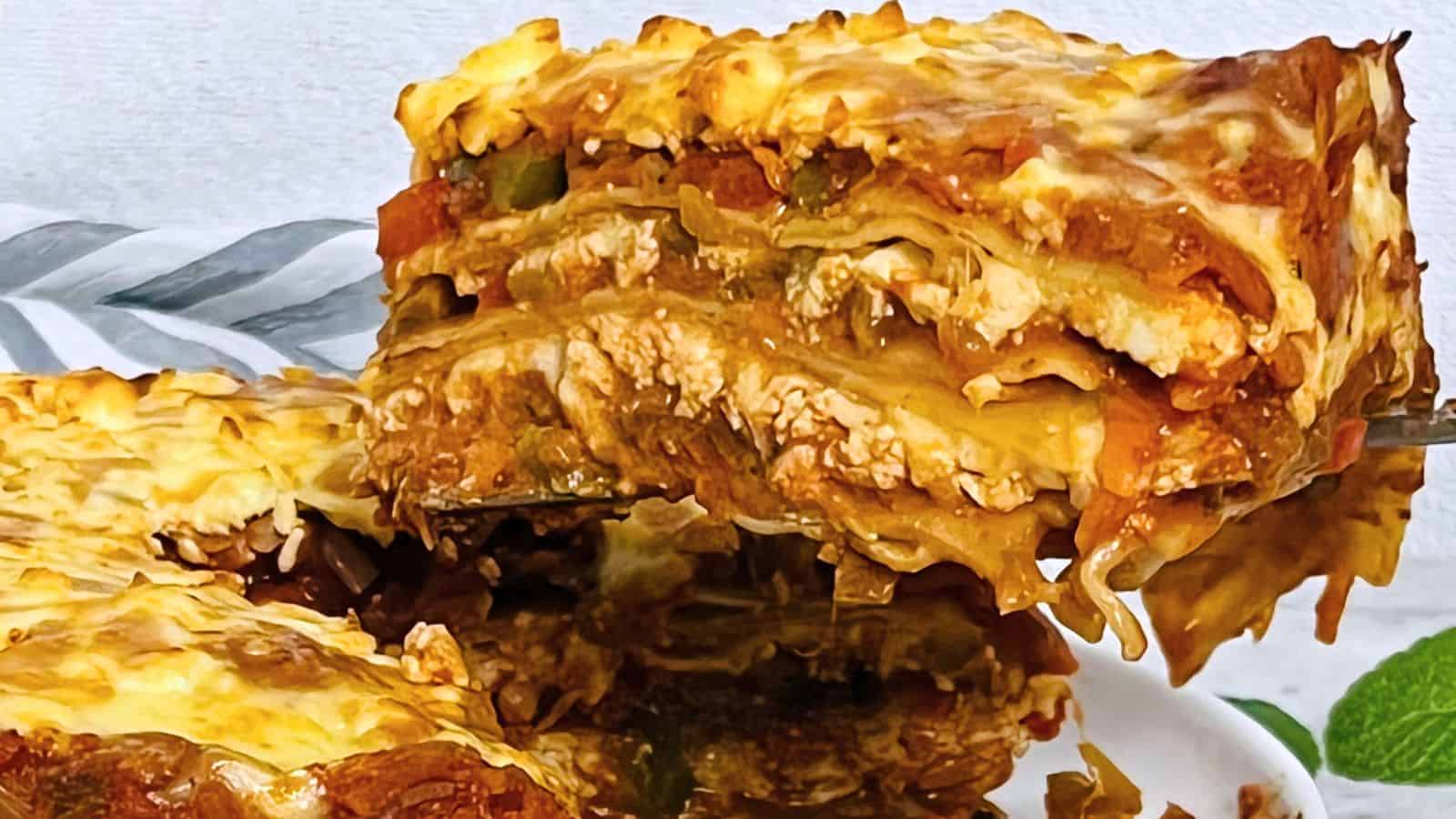 A close-up of a slice of Paneer Lasagna Instant Pot with visible layers of pasta, cheese, and tomato-based sauce.