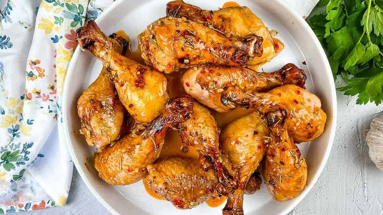 Smoked Chicken Legs with Red Pepper Glaze on a round platter.